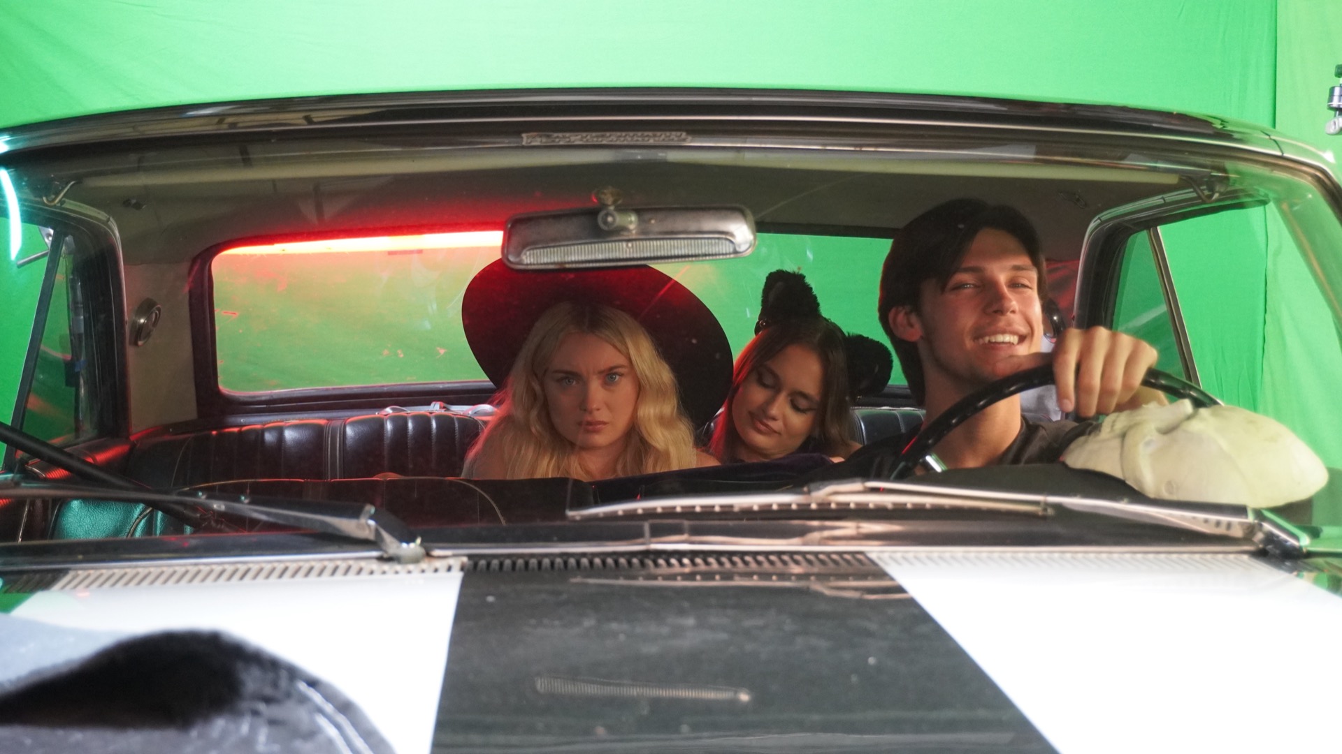 Raven Mocker actors filming a car scene on set